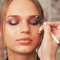 Model with closed eyes, the pomade is being applied