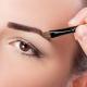 Close up of an model applying the medium brown pomade